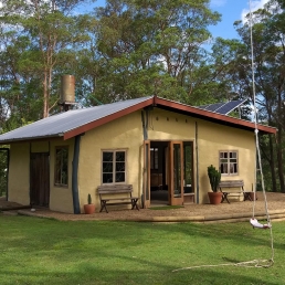 Kenilworth SnP235 - Queensland hilltop mudbrick cottage with views of cliffs and dairy farms has indoor and outdoor spaces for filming, photoshoots and events.